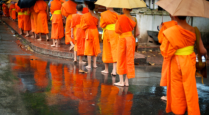 Rain or shine, monks line up every morning to collect alms.