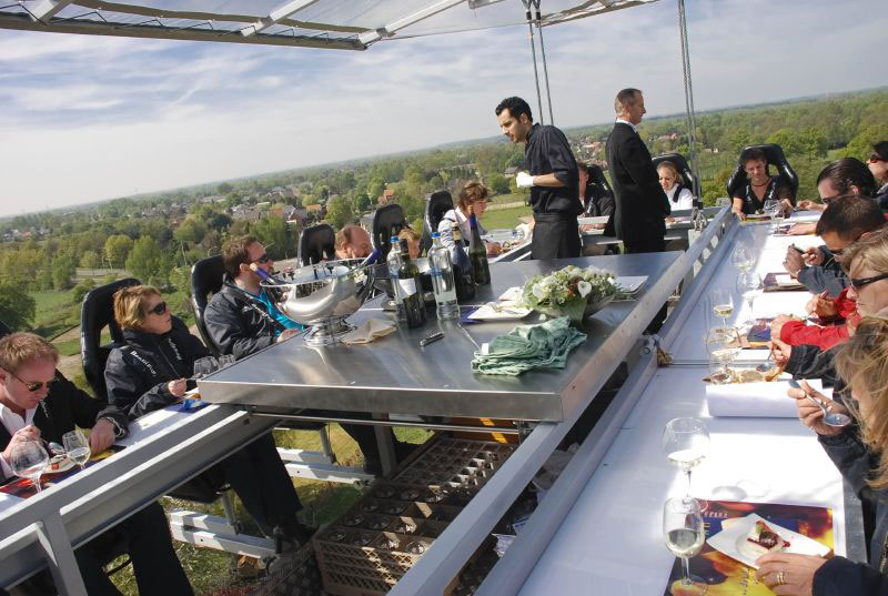 Diners enjoy delicious food and spectacular views at Dinner in the Sky. Photo by Everjean, cc. 