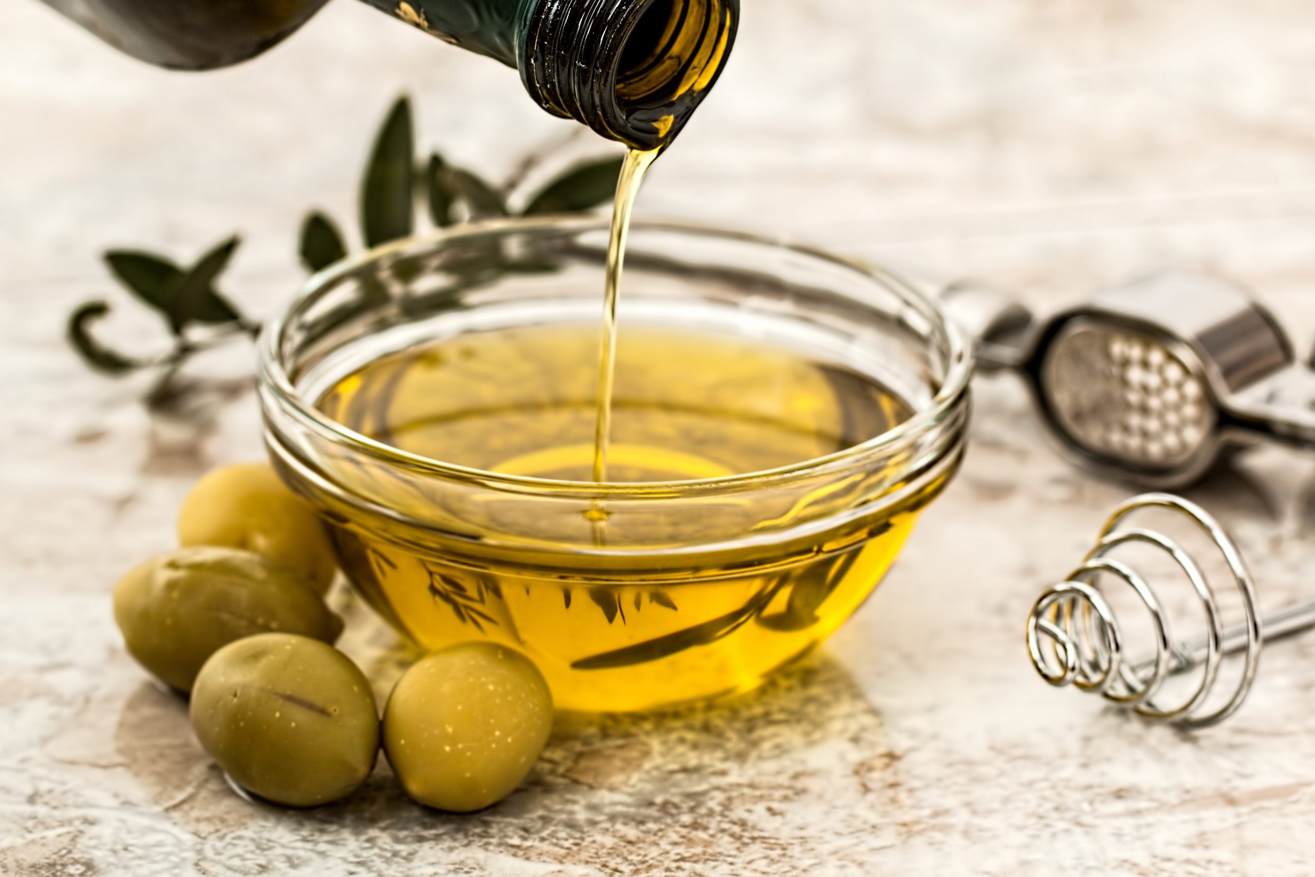 A glass bowl with olive oil in it